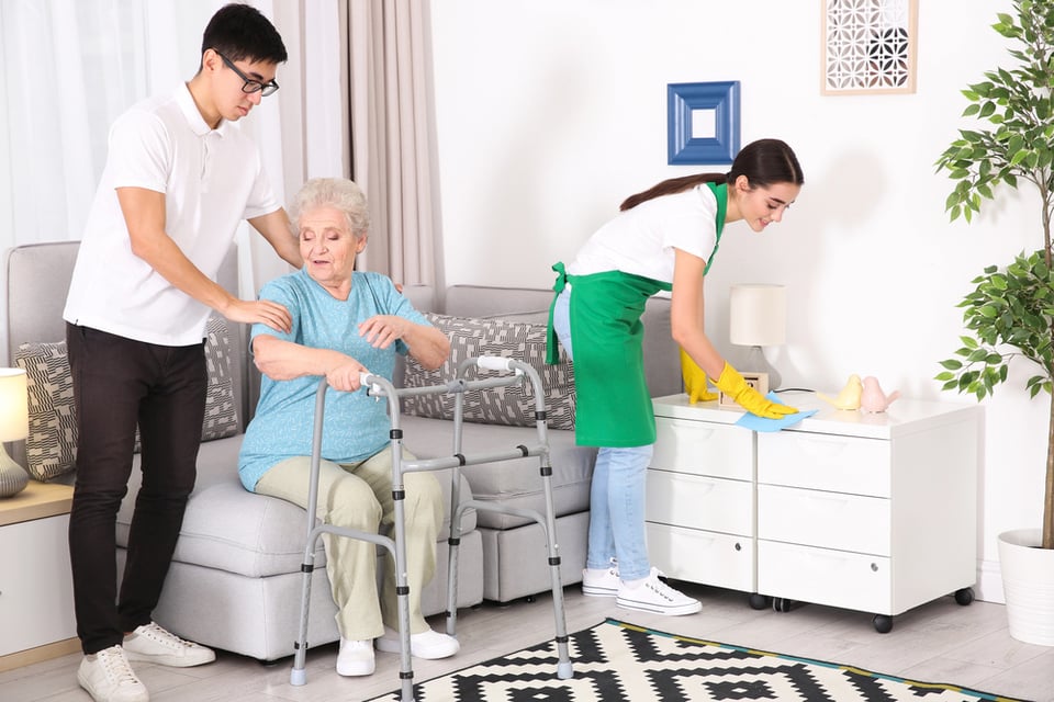 Senior woman with young caregivers at home