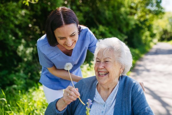 assisted-living-caregiver-elderly-woman-outdoor-care-2